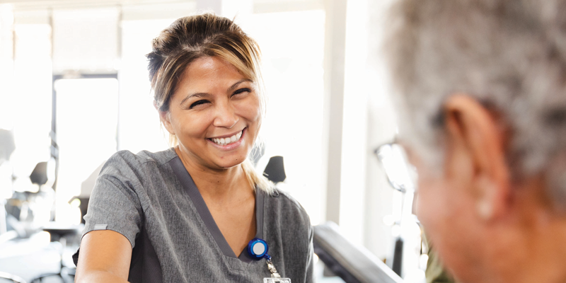 A PT smiling at a patient