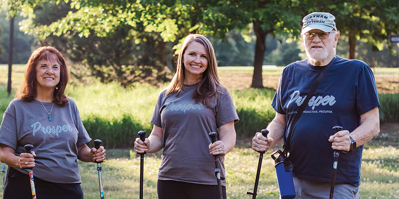 A PT walking with two patients