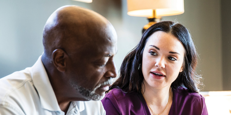 Two people seated and talking