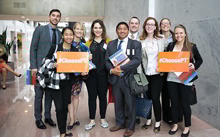 A group of people holding ChoosePT signs